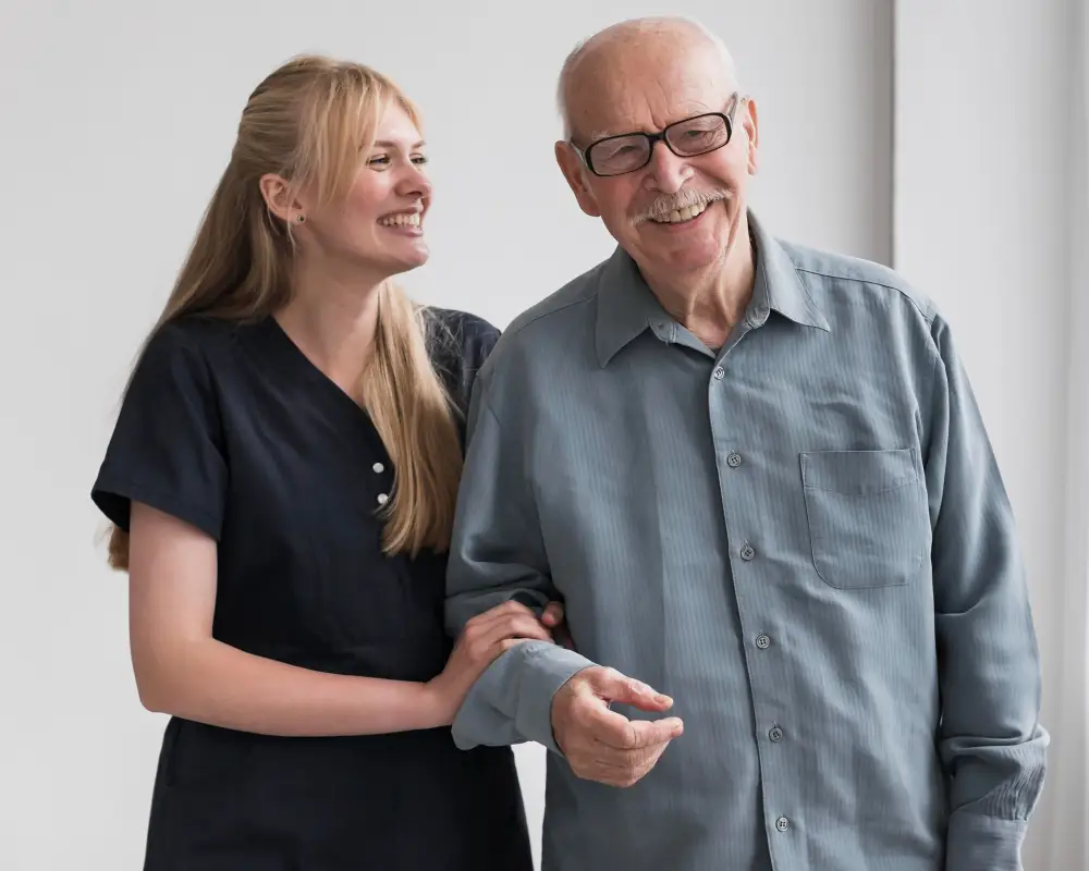 A carer holds the hand of an elderly gentleman, it shows the stresses that could lead to the carer needing care for carers therapy.