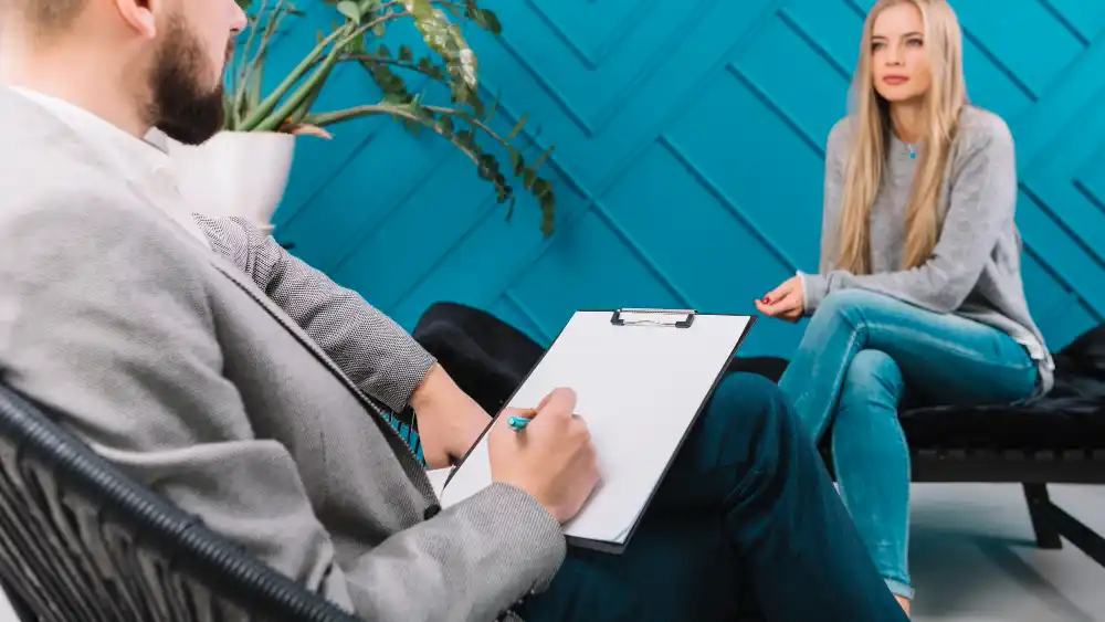 A woman talking to a therapist in her post abortion therapy session.